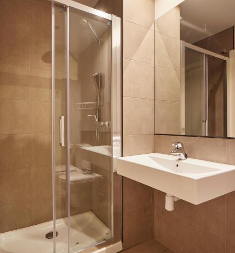a bathroom with a sink and a shower at Hotel Berri Versalles in Rentería