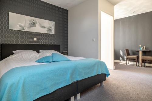 Кровать или кровати в номере Hotel Millingen