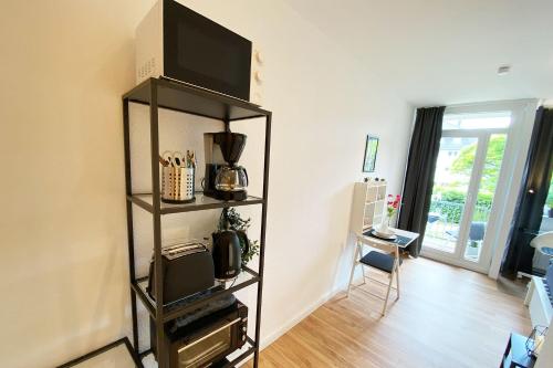 a living room with a television on a shelf at Business & Tourist Apartment with Balcony in Osnabrück