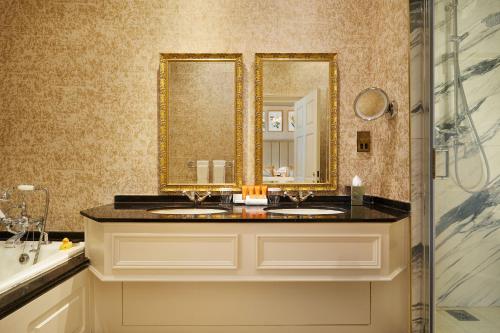 a bathroom with two sinks and a mirror at The K Club in Straffan