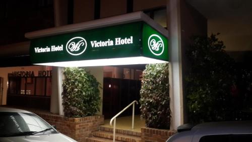 a sign for a vattenfield hotel in front of a building at Victoria Hotel in Bredasdorp