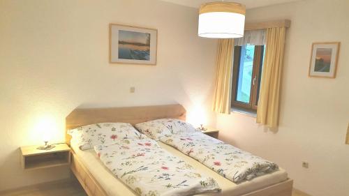 a bed in a bedroom with two lamps on tables at Mitterhirschberg, Familie Schweighuber in Waidhofen an der Ybbs