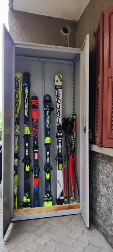 a closet with snowboards and skis in it at Baita Carmen Bormio in Bormio