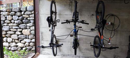 two bikes are hanging on a wall at Baita Carmen Bormio in Bormio