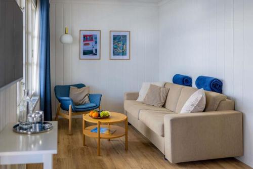 a living room with a couch and a table at Hørby Færgekro in Holbæk