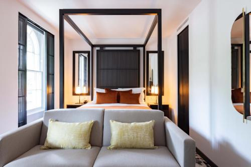a living room with a bed and a couch at La Suite West - Hyde Park in London