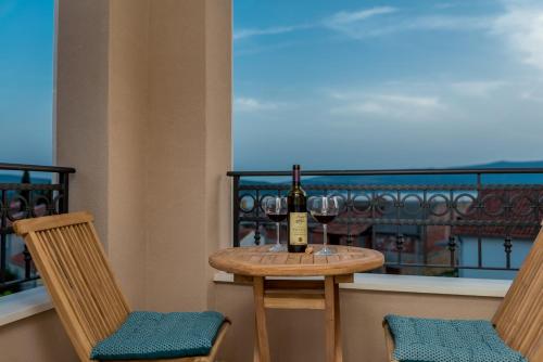 una mesa con una botella de vino y dos sillas en Luxury Apartments Ivanovic, en Tivat