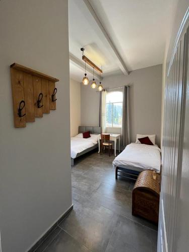 a room with two beds and a table in it at Diamond Apartment In Haifa in Haifa