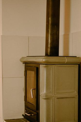 a metal oven with a pot on top of it at Almhaus Kochjosel in Garanas