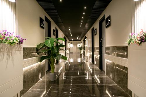 a hallway of a building with a plant on the floor at Metropole Hotel in Murree