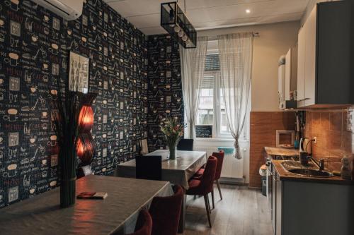 a kitchen and dining room with a table and chairs at Palmers Lodge Hostel in Zagreb