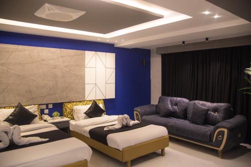a living room with two beds and a couch at Metropole Hotel in Murree