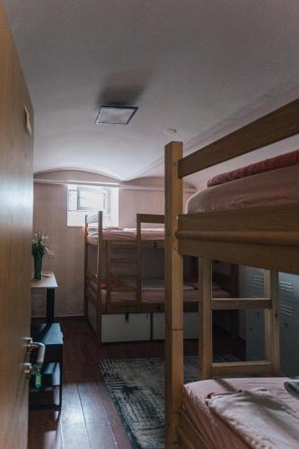 a room with two bunk beds and a window at Palmers Lodge Hostel in Zagreb