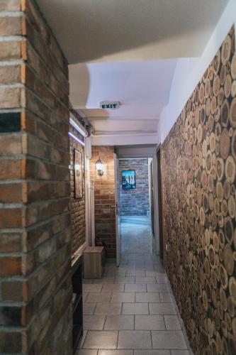 a hallway of a building with a brick wall at Palmers Lodge Hostel in Zagreb