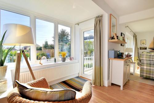 a living room with a chair and a window at Highpoint Lodge in Lyme Regis