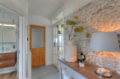a bathroom with a table with a lamp on it at Highpoint Lodge in Lyme Regis