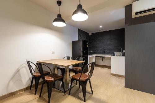 a kitchen and dining room with a table and chairs at Siam Star Hotel in Bangkok