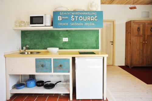 a small kitchen with a sink and a green chalkboard at Degustarium Bavory in Bavory