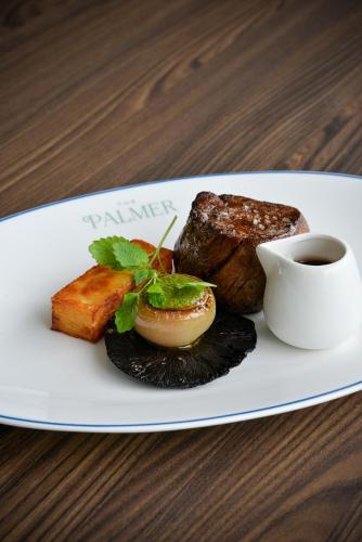 a plate of food with meat and a cup of coffee at The K Club in Straffan