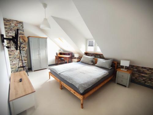 a bedroom with a large bed in a attic at Forsthof Nunkirchen in Wadern