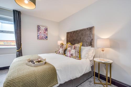 a bedroom with a large bed and a window at Central Belfast Apartments: Botanic in Belfast