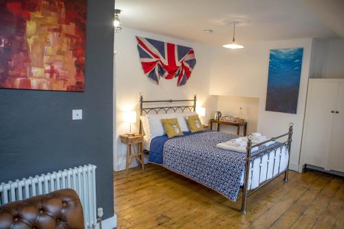 a bedroom with a bed and a flag on the wall at No4 Cromer in Cromer