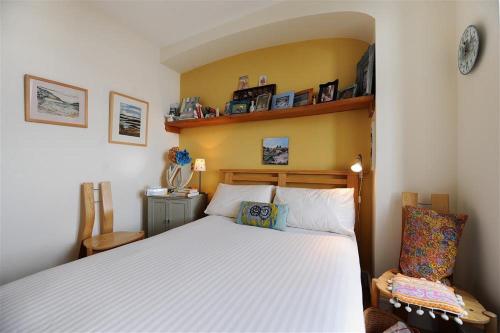 a bedroom with a white bed in a room at 6 Coram Tower in Lyme Regis