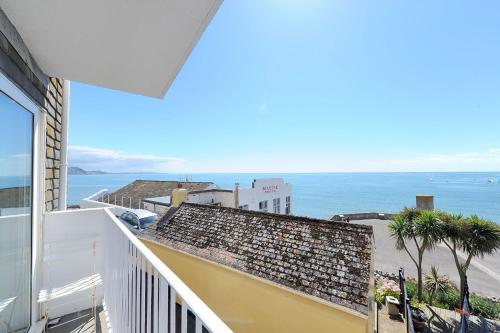 a balcony with a view of the ocean at 6 Bay View Court in Lyme Regis