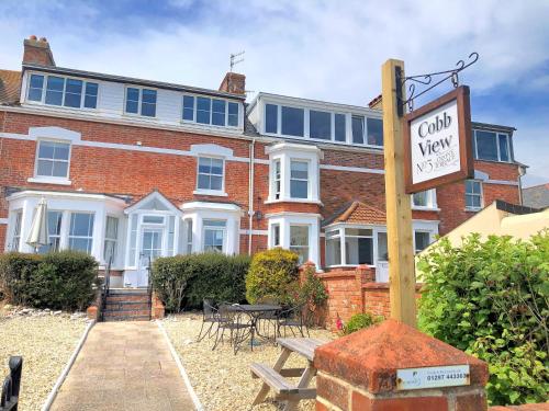 a brick building with a sign in front of it at 2 Cobb View in Lyme Regis