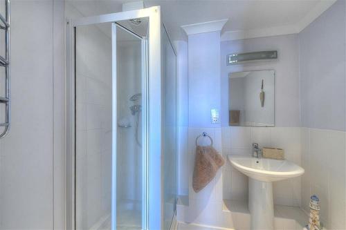 a bathroom with a shower and a sink at 9 Maritime House in West Bay