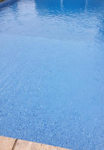 a large pool of blue water with at Richlands Homestay in Tondu
