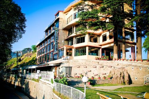 a large building on the side of a street at Metropole Hotel in Murree