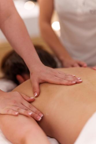 a woman getting a massage on her back at Hotel Fontana Vrnjačka Banja in Vrnjačka Banja