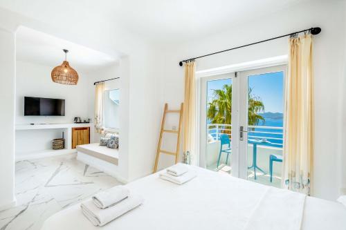 a bedroom with a bed and a view of the ocean at Payam Hotel in Kas