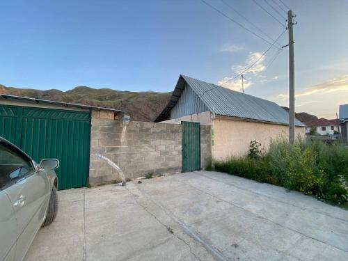 纳伦Rozalinda Guesthouse的停在大楼旁边的停车场的汽车