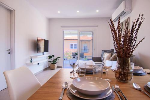 a dining room with a table with plates and silverware at Phaedrus Living Seaside Luxury Limnaria 172 in Paphos City