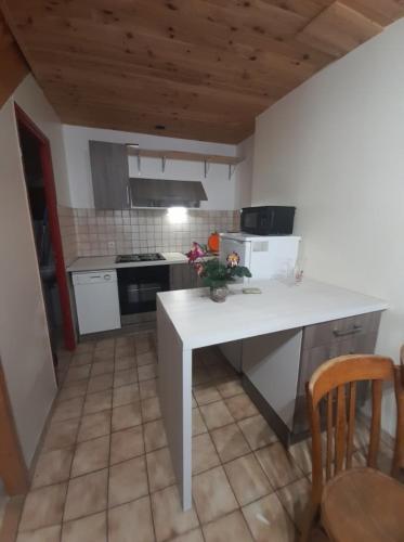 a kitchen with a white counter top in a room at Marmotte - Apartment near the cable car in La Grave in La Grave