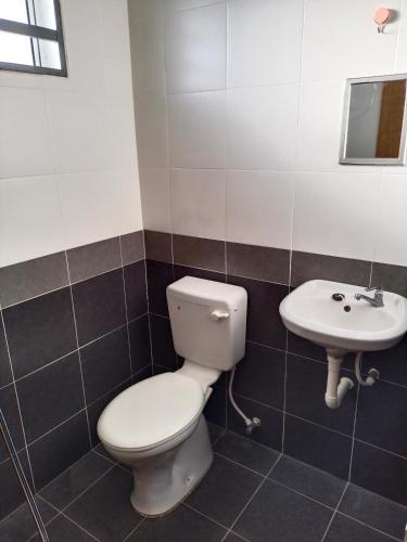 a bathroom with a toilet and a sink at WAFID HOMESTAY SERI ISKANDAR in Seri Iskandar