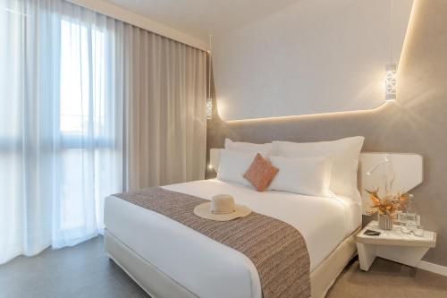 a hotel room with a bed with a hat on it at Pestana CR7 Marrakech in Marrakech