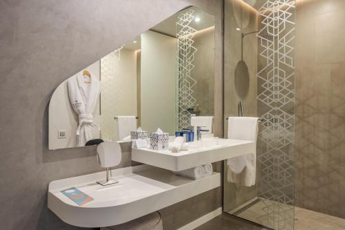 a bathroom with a sink and a mirror at Pestana CR7 Marrakech in Marrakech