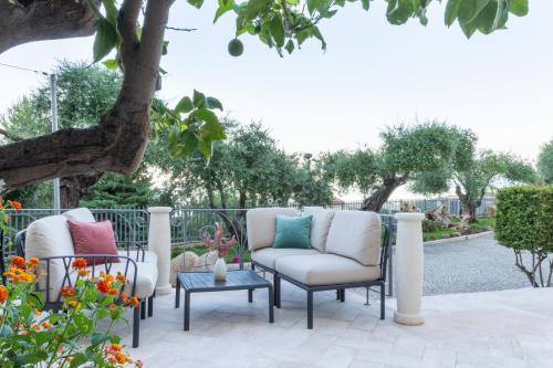 a group of chairs sitting on a patio at Hotel Brancamaria in Cala Gonone