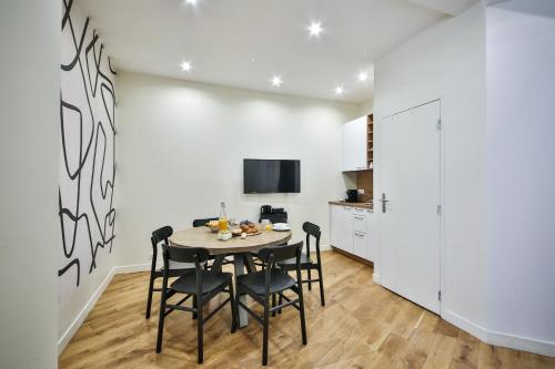 une cuisine et une salle à manger avec une table et des chaises dans l'établissement New Triplex 6Pers#ETOILE#Porte Maillot#Porte Champerret, à Paris
