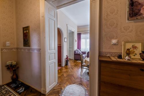 a hallway with an open door to a living room at Apartment Panorama Central in Novi Sad