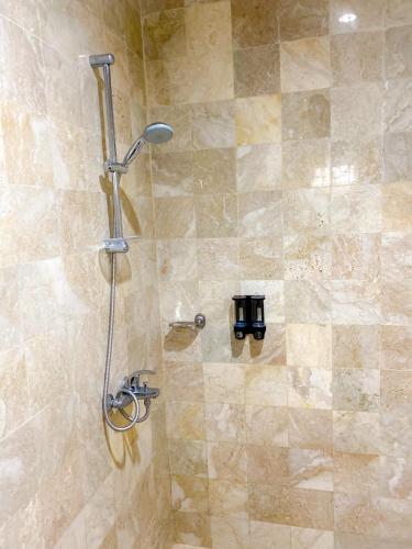 a shower in a bathroom with a glass door at Villa Andalus 1&2 in Puncak