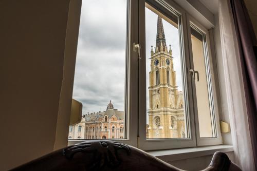 a window with a view of a clock tower at Apartment Panorama Central in Novi Sad