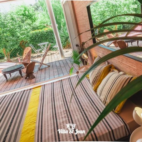 a porch with a couch and a plant at La Villa Saint Jean BAS DE VILLA in La Ciotat