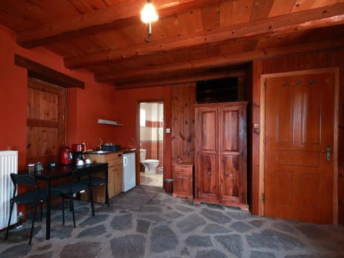 a kitchen with wooden walls and a table and chairs at Agriogido - Rupicapra Villas in Papigko