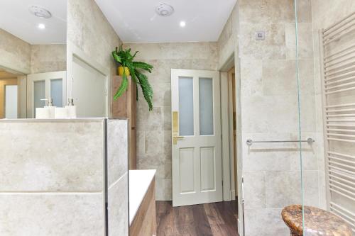 a bathroom with a shower and a glass door at Cinnabar: Luxury, Couple's Nook in Historic Walls. in Berwick-Upon-Tweed