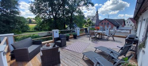 terraza con sillas y mesa en el balcón en Ferienwohnungen Marienweiher, en Marktleugast