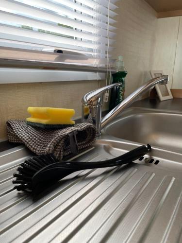a black brush sitting on a kitchen sink at Bosuns Reach in Cockwood